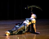 Melina performs a breath taking belly dance while balancing a sword on the tip of a dagger