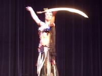 Melina performs a breath taking belly dance while balancing a sword on the tip of a dagger 122