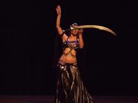 Melina performs a breath taking belly dance while balancing a sword on the tip of a dagger 120