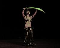 Melina performs a breath taking belly dance while balancing a sword on the tip of a dagger 7